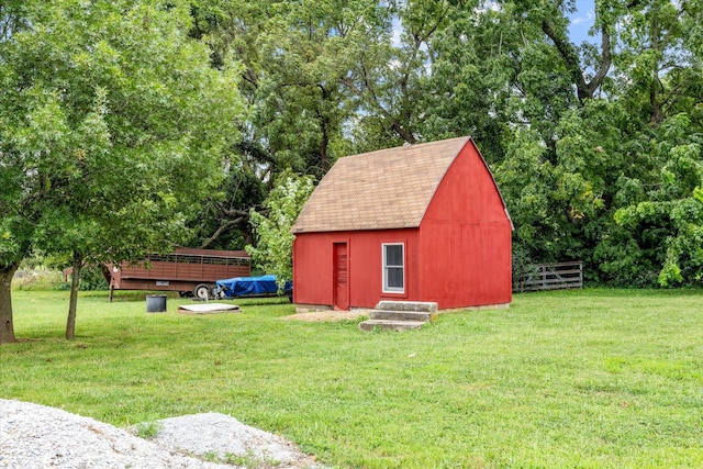 view of outbuilding featuring a yard