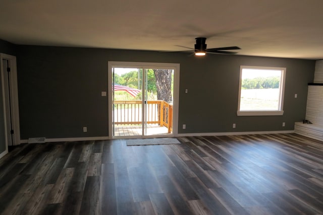 empty room with baseboards, visible vents, dark wood-type flooring, and ceiling fan