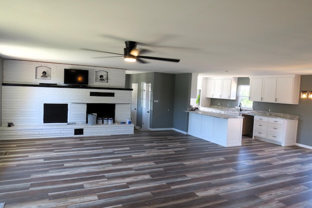 kitchen featuring white cabinets, dark wood finished floors, a ceiling fan, baseboards, and open floor plan