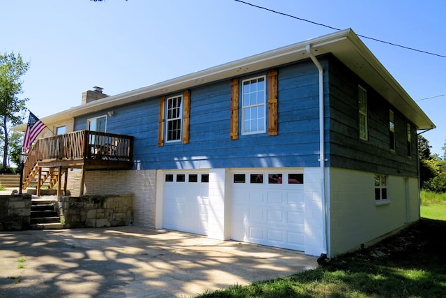 view of front of property with a chimney, stairs, a wooden deck, driveway, and a garage