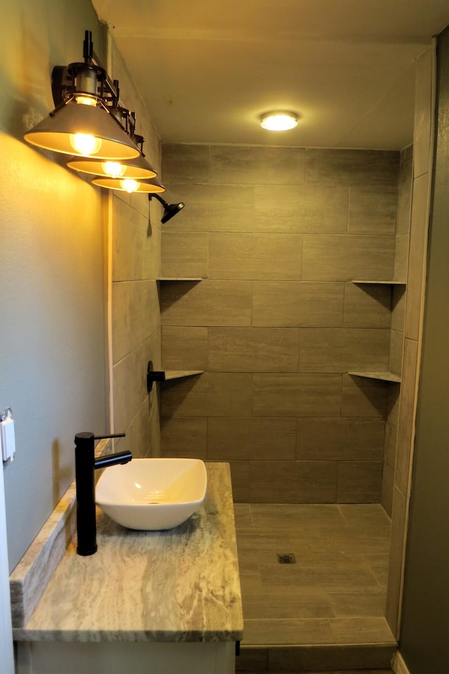 bathroom featuring vanity and a tile shower