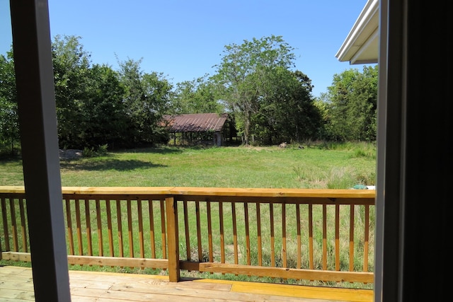 wooden deck with a lawn