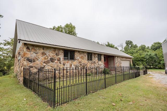 exterior space featuring a garage and a front lawn