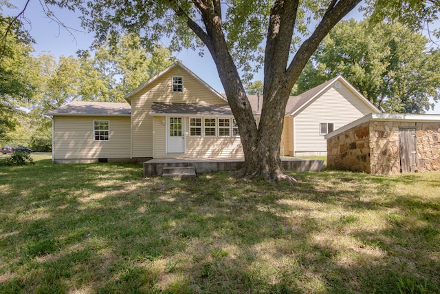 rear view of house with a yard