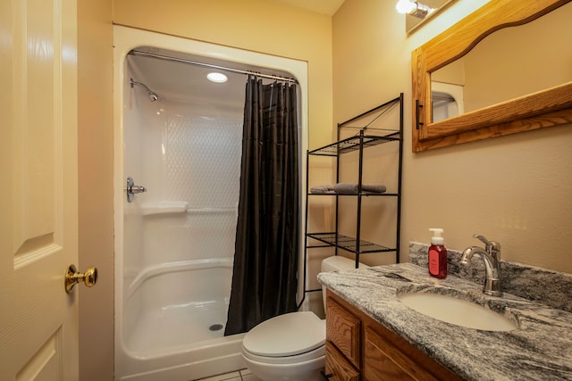 bathroom featuring tile patterned floors, a shower with shower curtain, vanity, and toilet