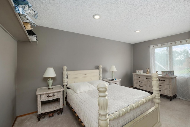 bedroom with baseboards, a textured ceiling, recessed lighting, and light colored carpet