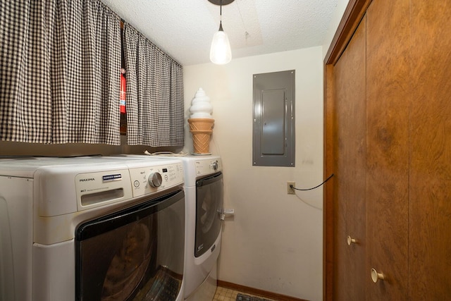 clothes washing area featuring laundry area, electric panel, washing machine and clothes dryer, baseboards, and a textured ceiling
