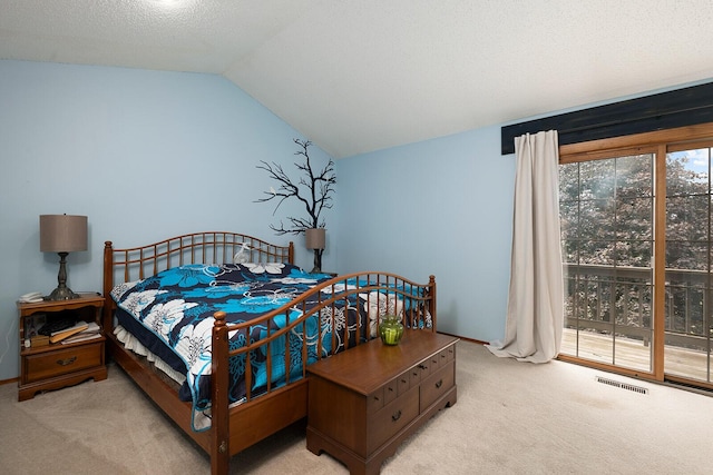 bedroom with vaulted ceiling, carpet floors, visible vents, and access to outside