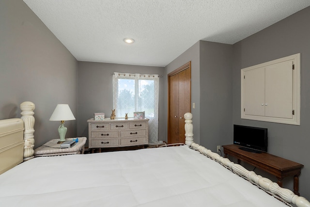 bedroom with a textured ceiling and a closet