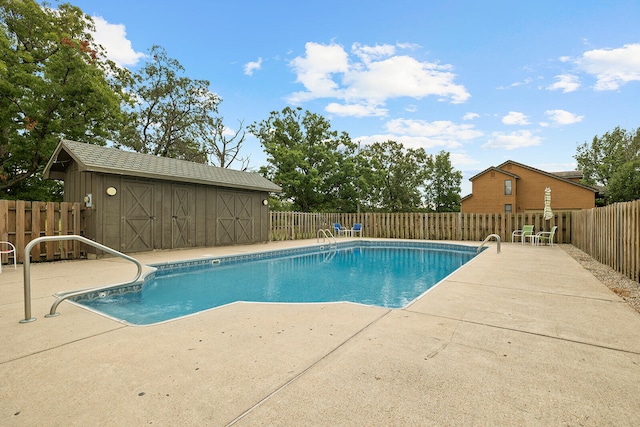 view of pool with a storage shed and a patio area