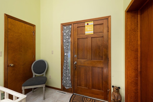 foyer entrance with baseboards, visible vents, and light tile patterned floors