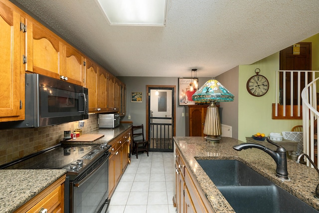 kitchen with electric range, decorative backsplash, sink, pendant lighting, and a textured ceiling