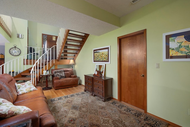 living room featuring hardwood / wood-style flooring and a textured ceiling