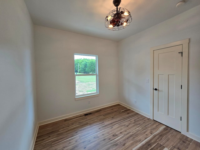 unfurnished room featuring hardwood / wood-style flooring