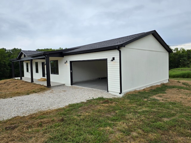 view of home's exterior with a garage and a lawn