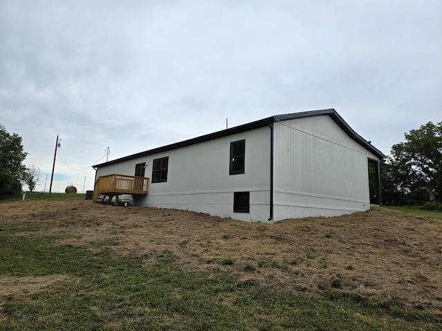 view of side of home featuring a yard