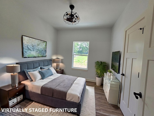 bedroom with dark hardwood / wood-style flooring