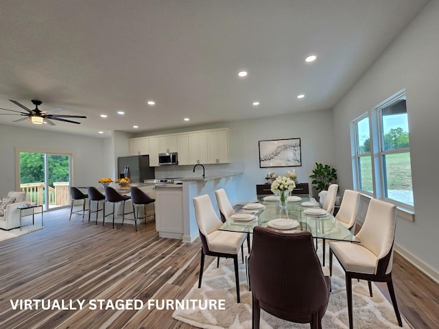 dining area with ceiling fan, hardwood / wood-style flooring, plenty of natural light, and sink