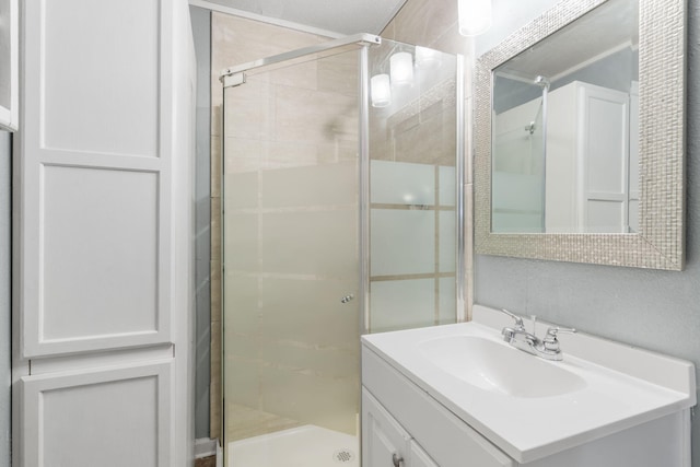 bathroom with vanity and a shower with door