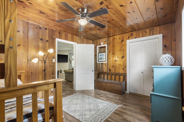 interior space featuring wood ceiling, wooden walls, and dark wood-type flooring