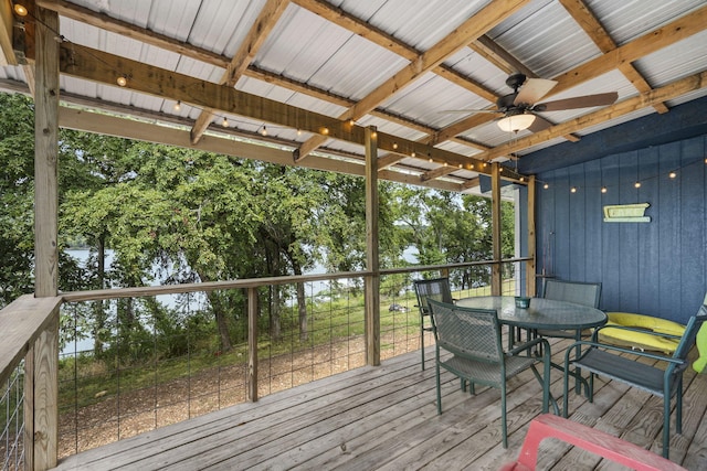 deck featuring ceiling fan and a water view