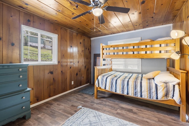 bedroom with dark hardwood / wood-style flooring, wooden walls, and wooden ceiling