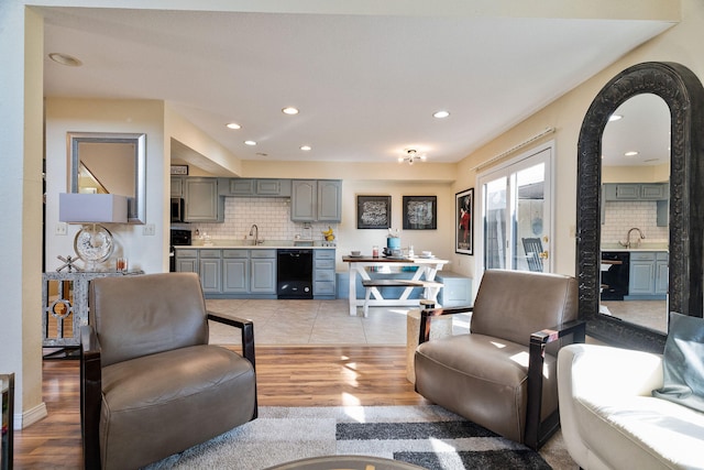 living room with sink and light hardwood / wood-style flooring