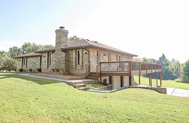 rear view of property with a yard and a deck