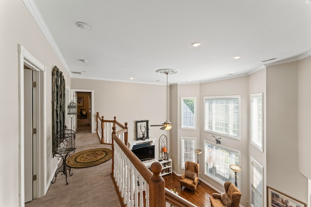 hallway featuring light colored carpet and crown molding