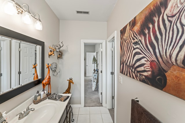 bathroom with tile patterned flooring and vanity