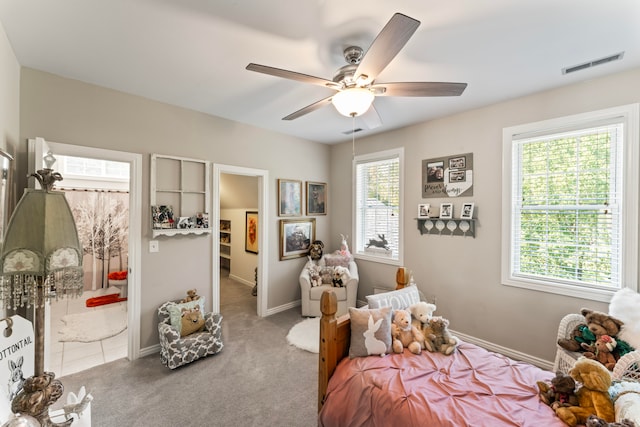 bedroom featuring carpet, multiple windows, and ceiling fan