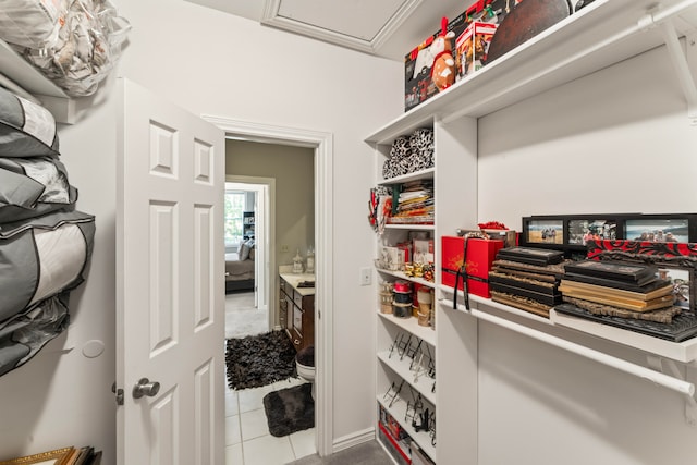 walk in closet with light tile patterned flooring