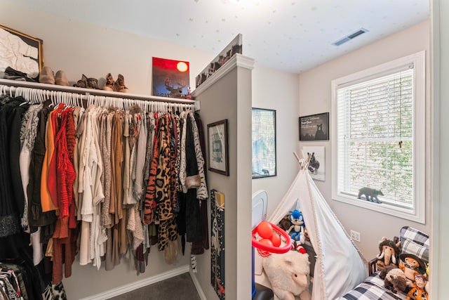 walk in closet featuring carpet floors