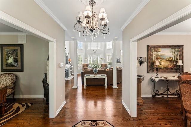 interior space featuring dark hardwood / wood-style floors, crown molding, and decorative columns