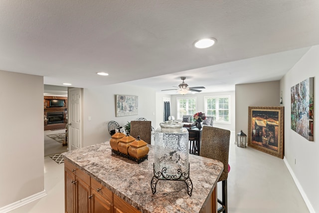 dining room with ceiling fan and a textured ceiling