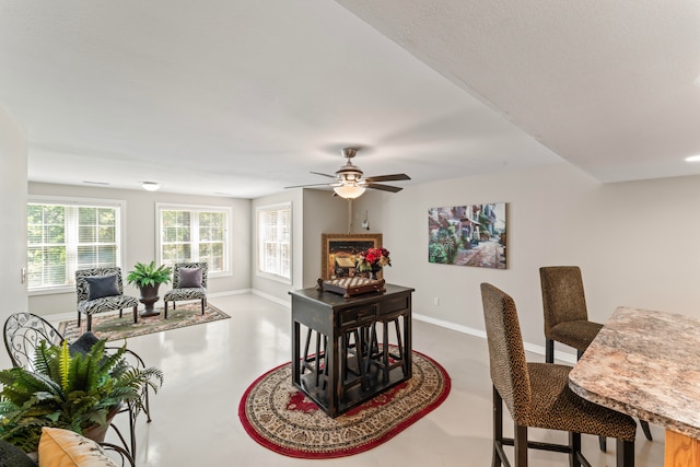 dining room featuring concrete flooring and ceiling fan