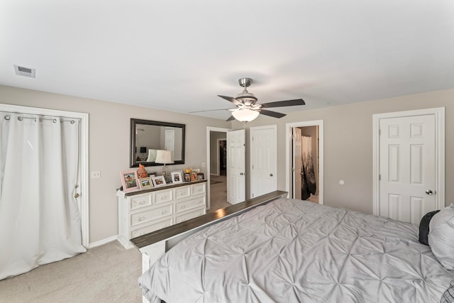 carpeted bedroom featuring ensuite bathroom and ceiling fan