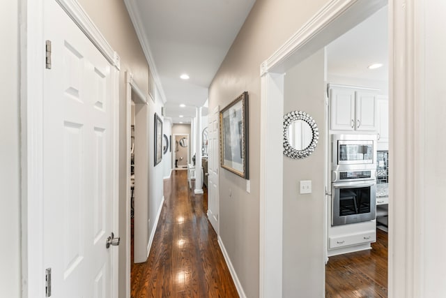 hall featuring crown molding and dark hardwood / wood-style flooring