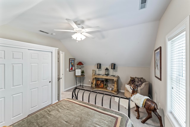 carpeted bedroom with lofted ceiling, ceiling fan, and a closet