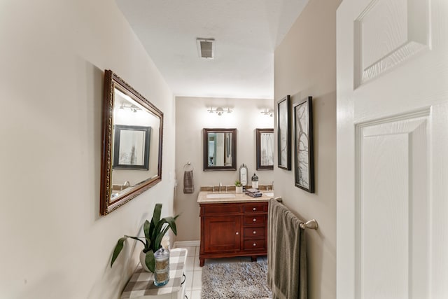 bathroom featuring tile patterned flooring, vanity, and a textured ceiling