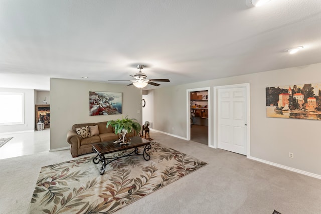 carpeted living room featuring ceiling fan