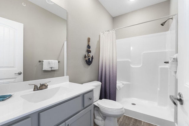 bathroom with toilet, vanity, curtained shower, and wood-type flooring