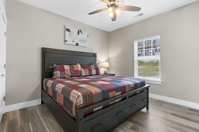 bedroom featuring light hardwood / wood-style flooring and ceiling fan