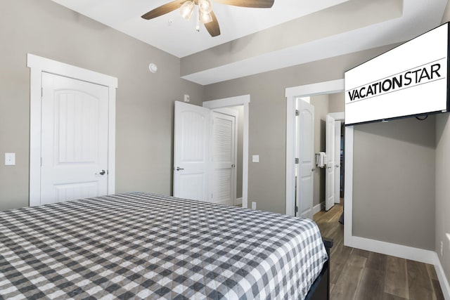 bedroom with a closet, dark hardwood / wood-style flooring, and ceiling fan