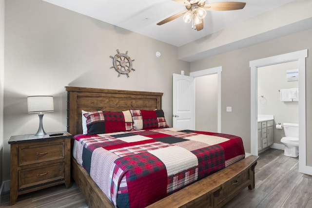 bedroom with dark hardwood / wood-style floors, ensuite bath, and ceiling fan