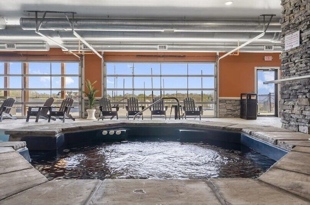 view of swimming pool with an indoor in ground hot tub