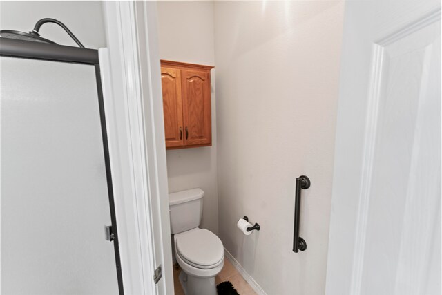 bathroom with tile patterned floors and toilet