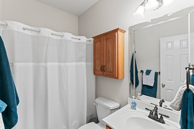 bathroom with vanity, toilet, and curtained shower