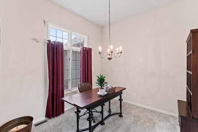 office space with a notable chandelier and light carpet