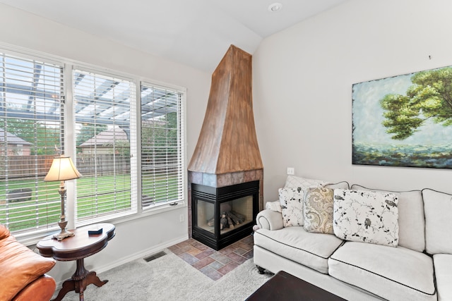 living room featuring a multi sided fireplace